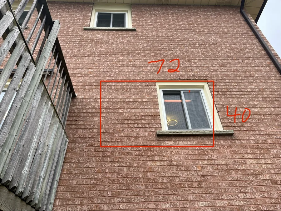 Brick wall marked out around the existing small kitchen window for the enlarged opening