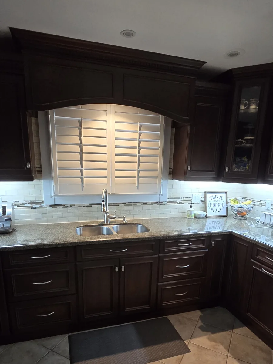 Kitchen window over the sink with california shutters reinstalled on the new window