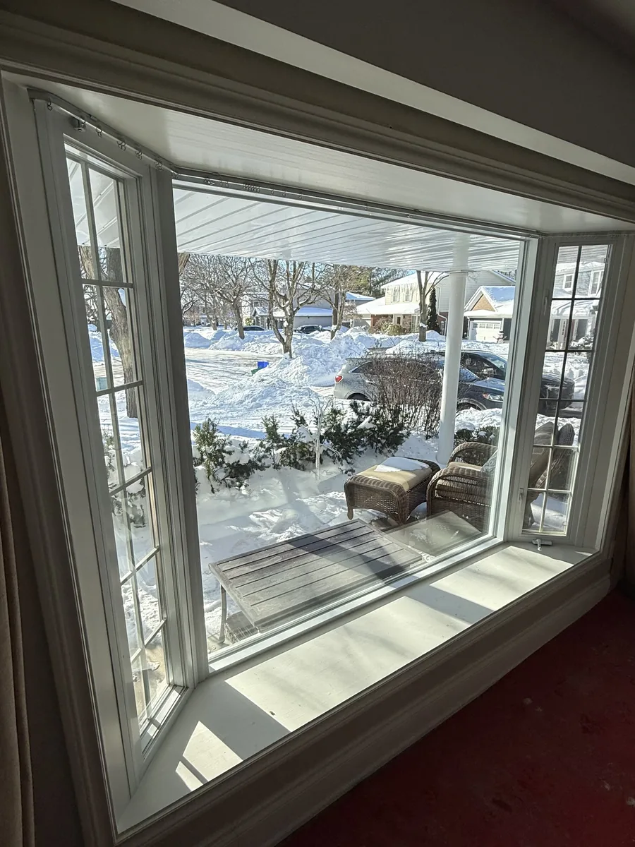 Before: the old white bay window from inside the Markham home, looking onto the snowy street