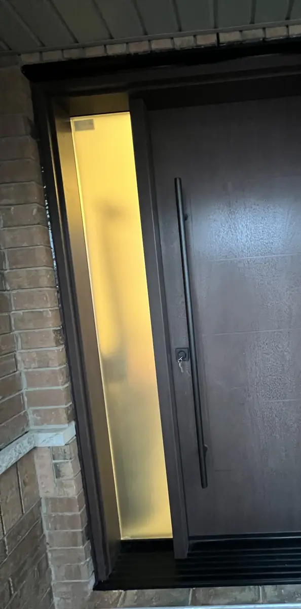 Matching stained 42-inch entry door with frosted sidelite installed on the neighbouring Mississauga house