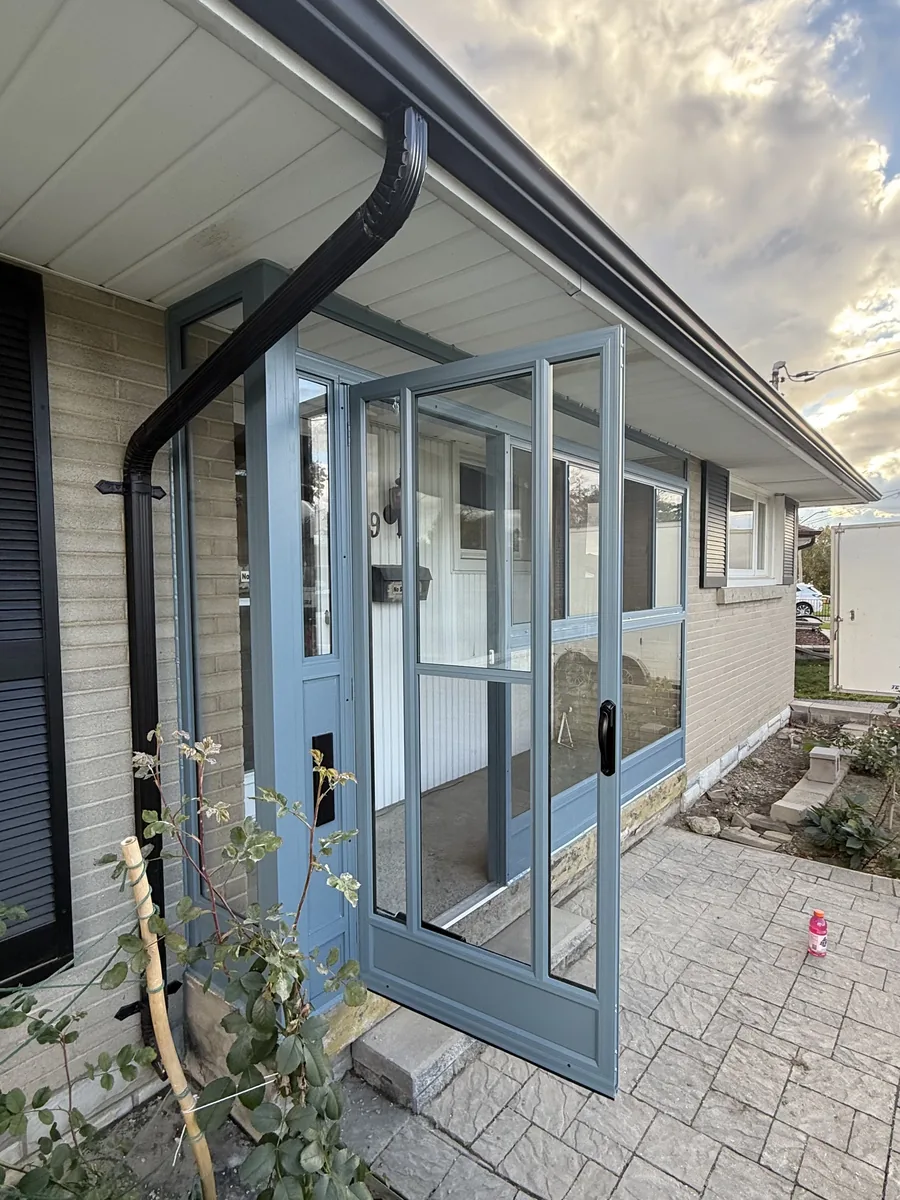The Wedgewood Blue enclosure door standing open on the new front porch