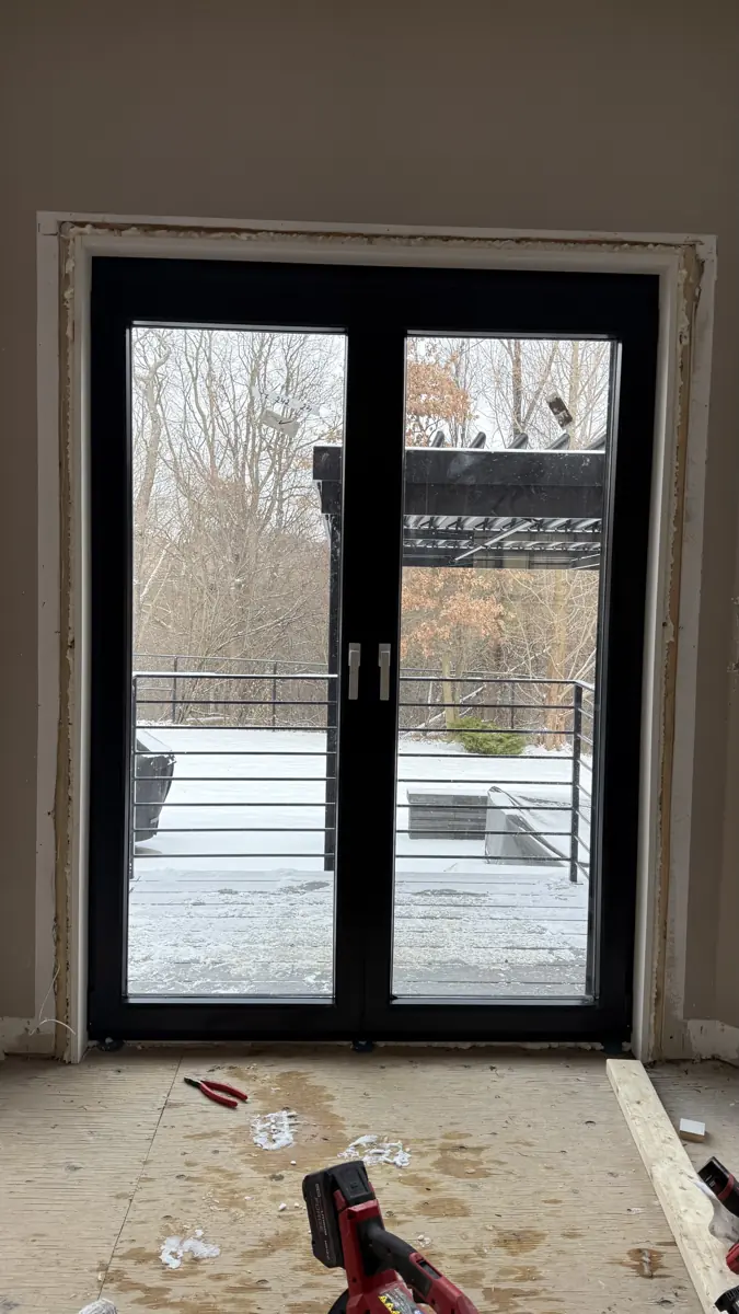 Finished black tilt-and-turn French doors seen from inside a Pickering home