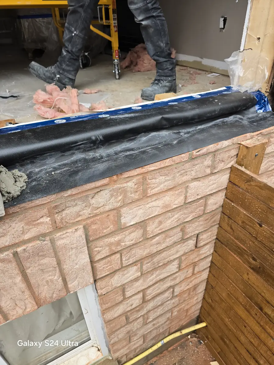 Window opening cut open and prepared for enlargement on a Pickering brick home