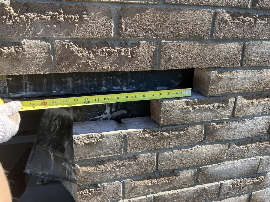 The new steel lintel measured and set into the brick coursing above the enlarged opening