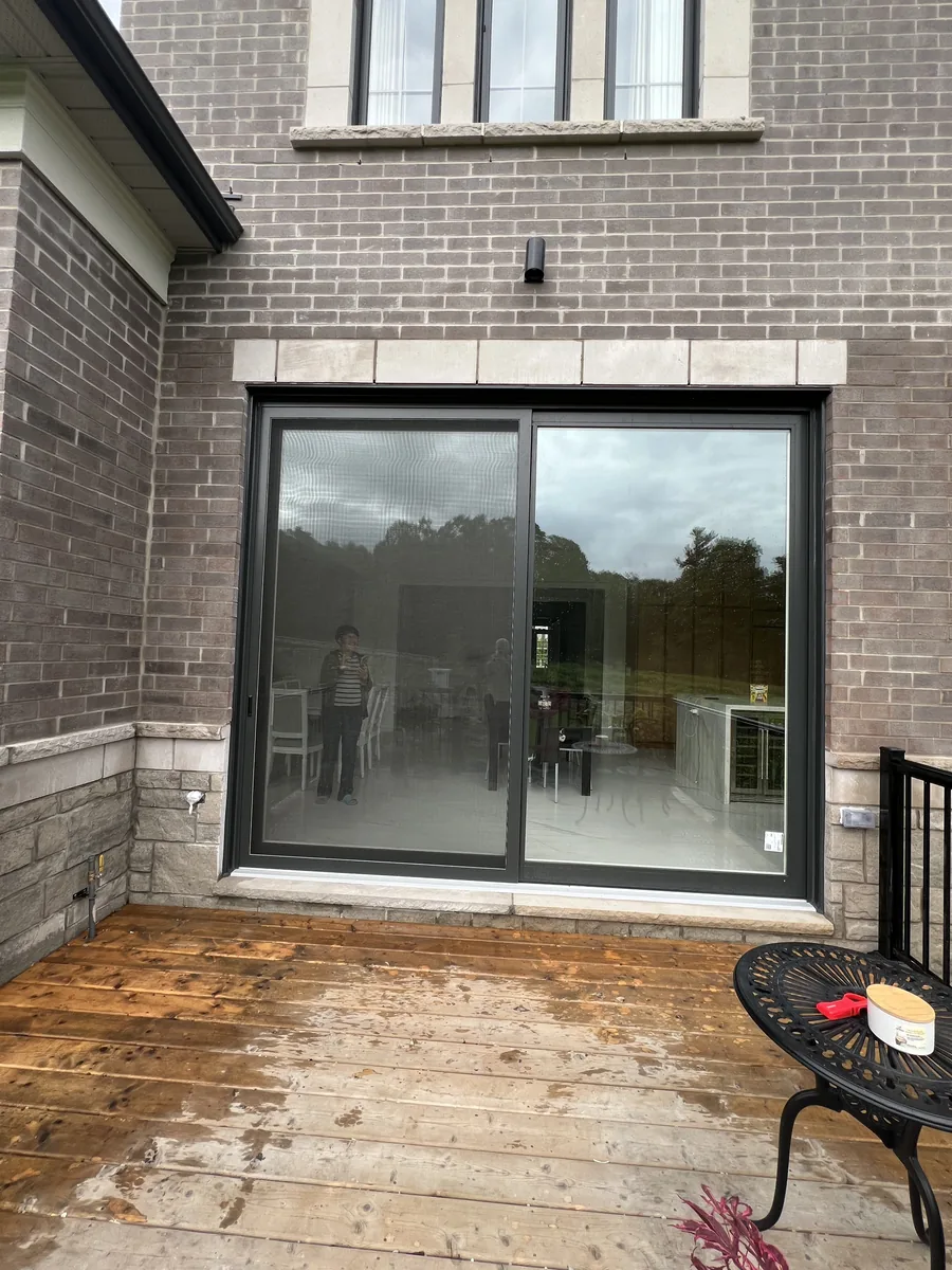 New Iron Ore charcoal patio door set brick-to-brick in the grey brick and stone wall of the Vaughan estate